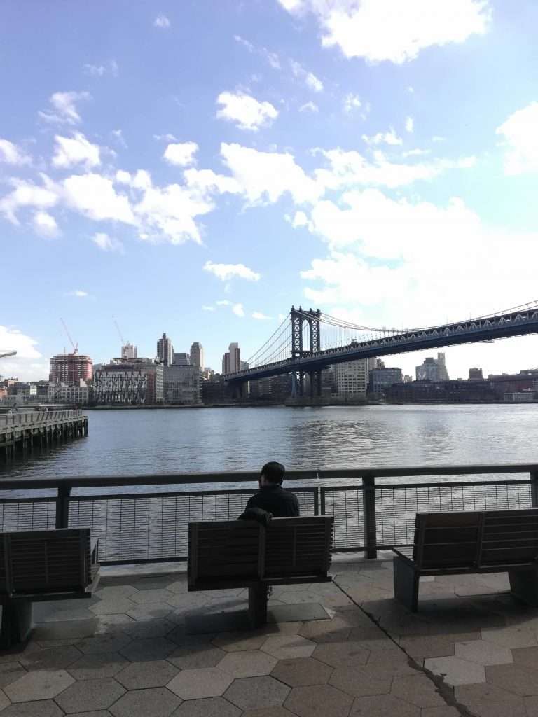 Lady sitting at East River park alone