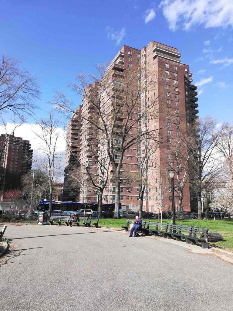 man sitting at bench park social distancing nyc