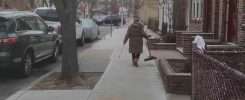 Woman cleaning sidewalk