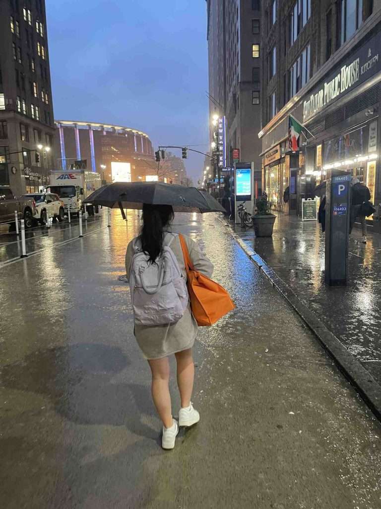 Woman walking holding umbrella during a rainy day